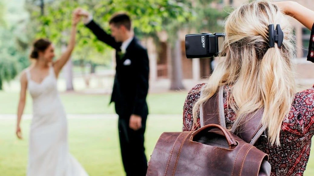 Wedding Photographer captures an image of a bride and groom dancing under a beautiful tree.