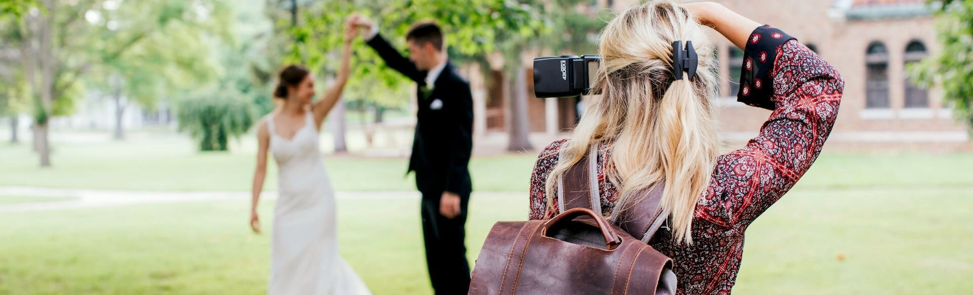 Wedding Photographer captures an image of a bride and groom dancing under a beautiful tree.