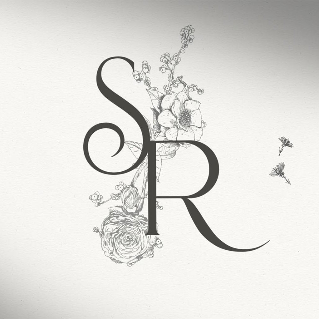 Monogram of SR with illustrated botanical flowers behind it.