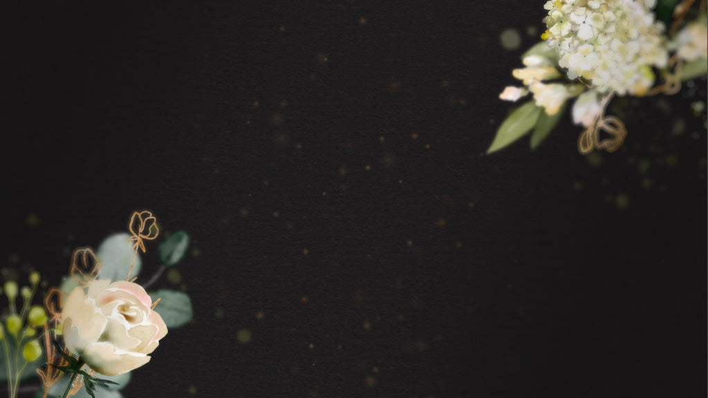 Black background with hints of white floral and with gold dust