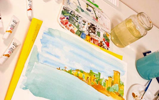 An artist painting a watercolour scene