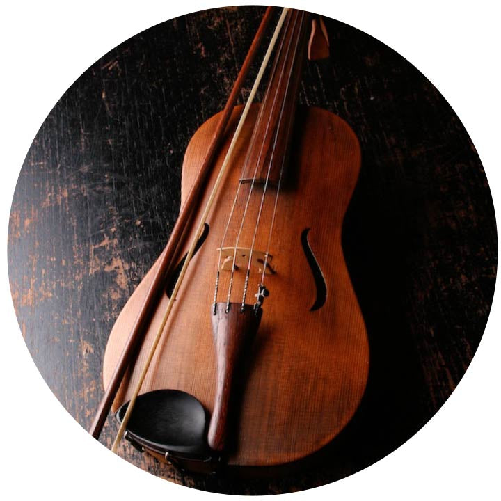 Cello and bow lying on a wooden floor