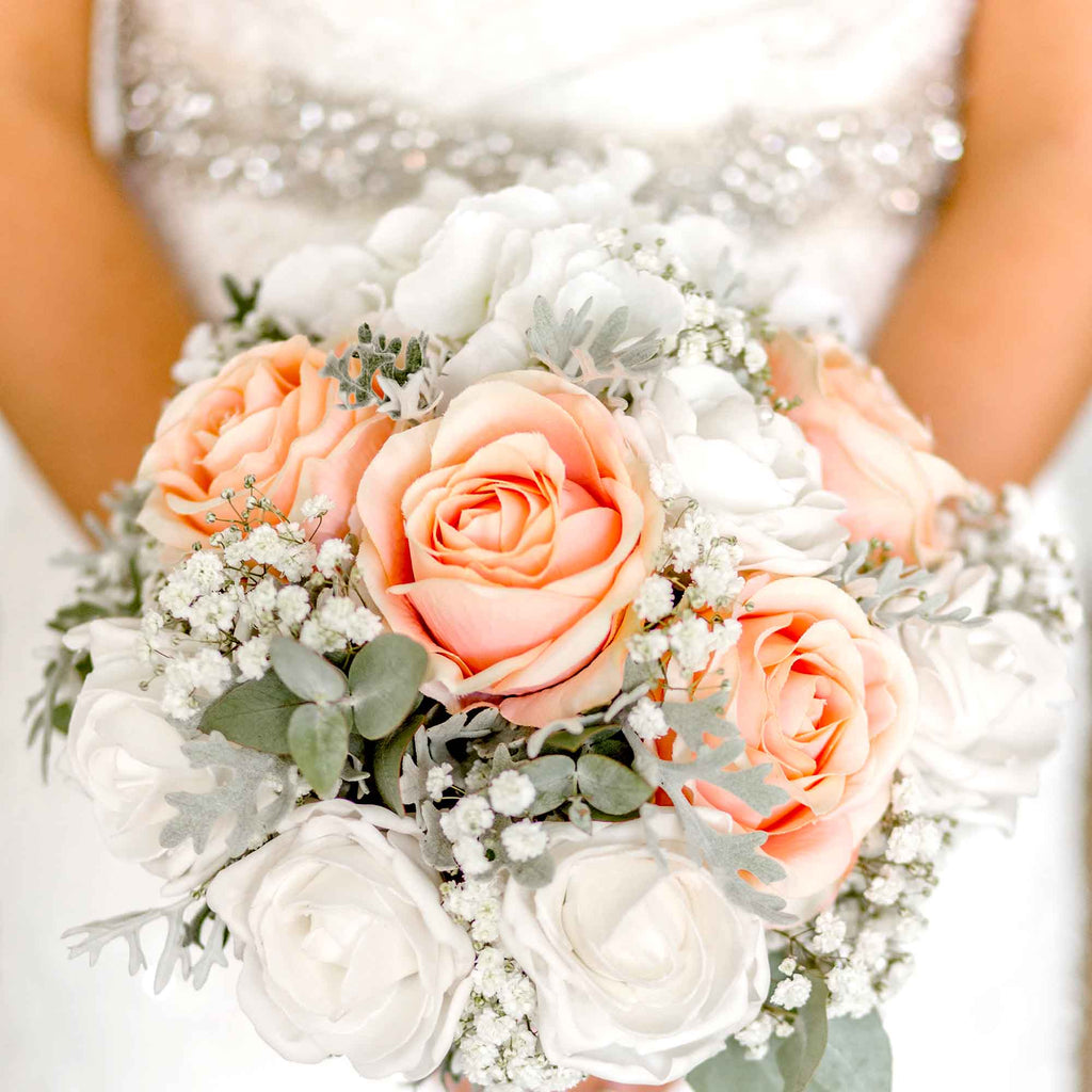Bride holding her wedding bouqet containing pink and white flowers