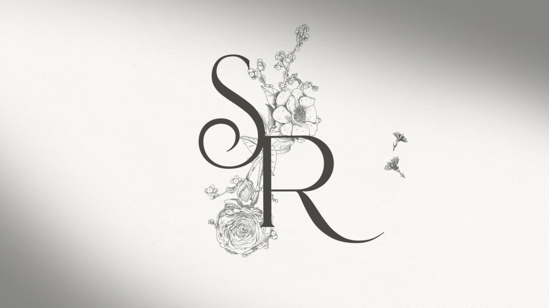 Classic black and white wedding monogram at the start of a wedding invitation.
