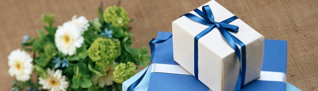 Wedding gifts wrapped and stacked in blue boxes with ribbon