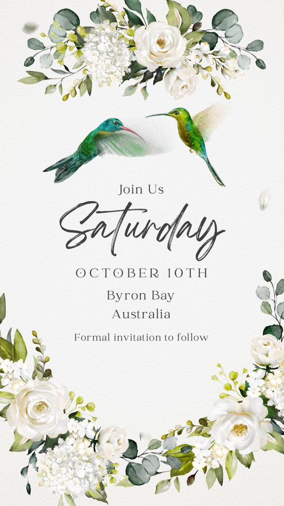 Elgant Blue and Green Hummingbirds flying around elegant invitation details and florals.