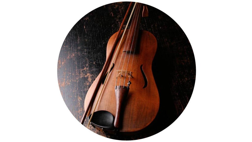 Cello and bow lying on a wooden floor