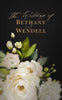 Luxury gold and white floral watercolor art sits on top of textured black card.