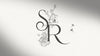 Classic black and white wedding monogram at the start of a wedding invitation. 