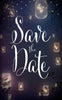Save the date is written in a whimsical font with fireflies in jars hung up in a tree is its backdrop. 