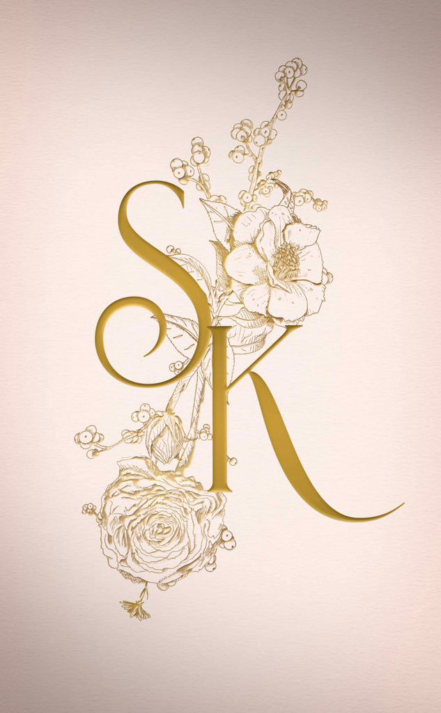 Vintage botanical illustrations are a gold bouquet with the initials S K written over the top in an elegant font
